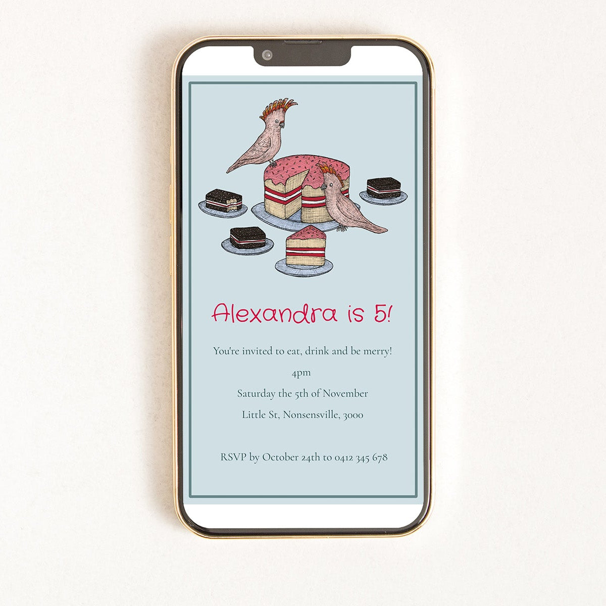 Phone displaying a birthday invitation with cockatoo and cake illustration on a light blue background