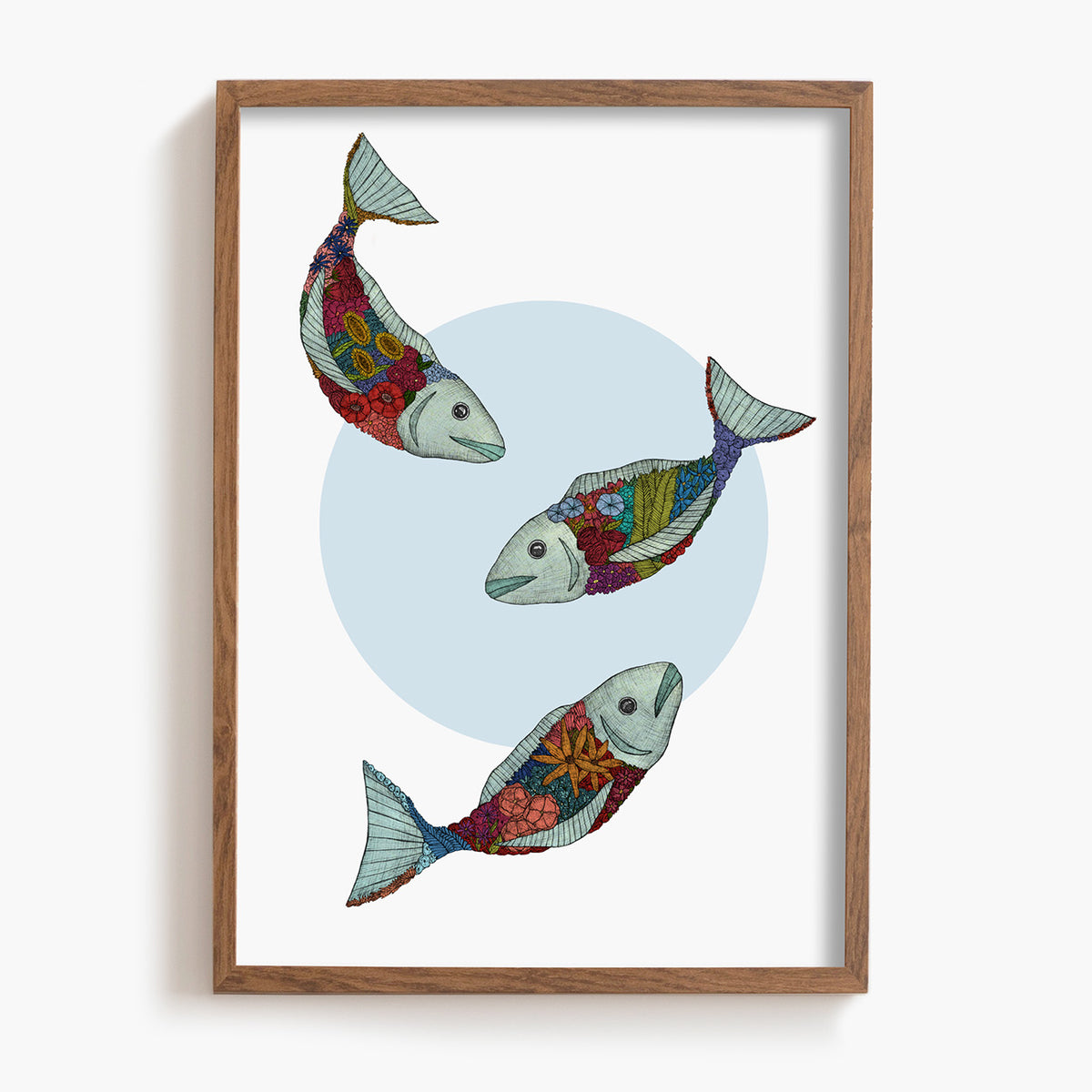 Framed artwork of three colorful fish on a white background