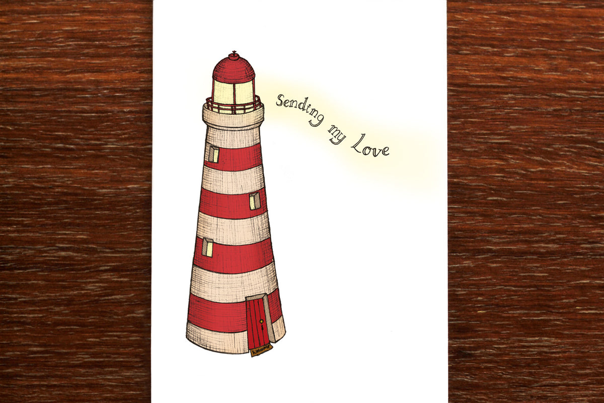 Lighthouse Love Sympathy Card on wooden backdrop