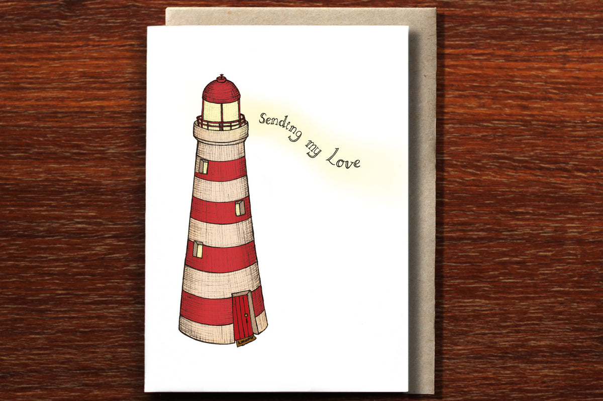 Sympathy Lighthouse card with envelope on wooden backdrop