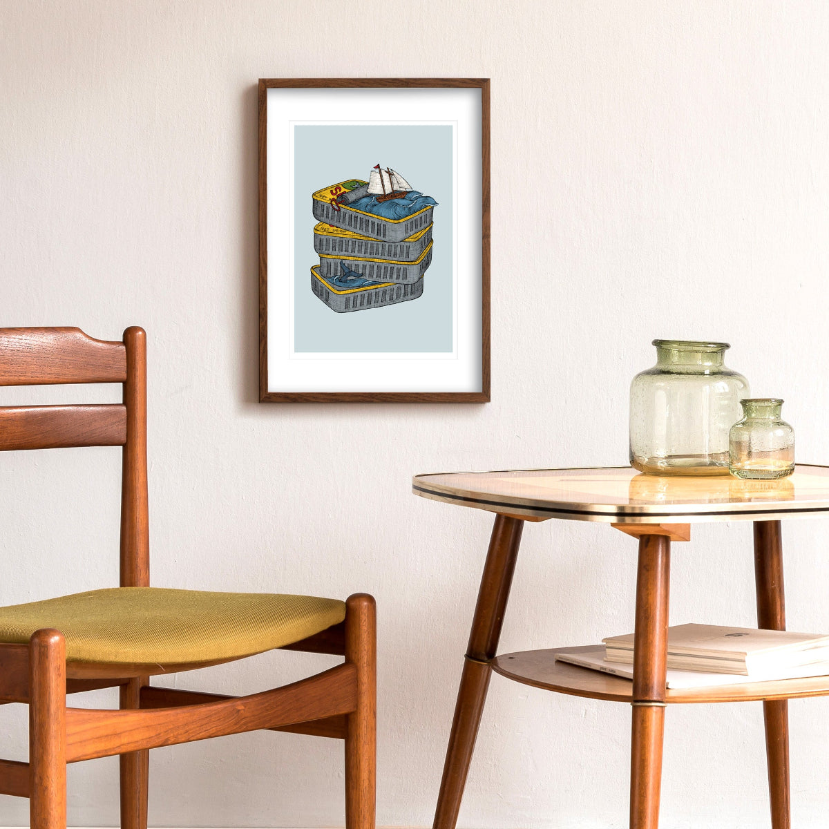 Wooden chair and table with framed artwork of a Sardine Can on a wall