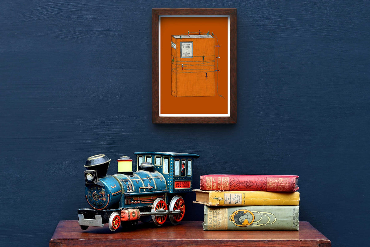 Gulliver's Travels art framed on a blue wall