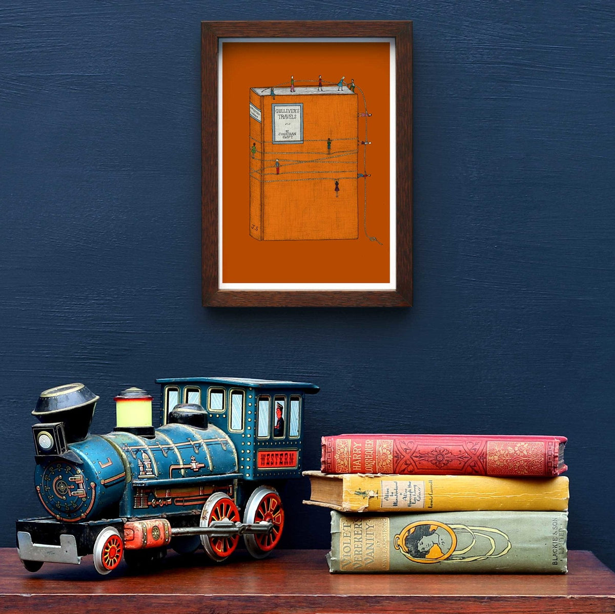 Gulliver's Travels art framed on a blue wall