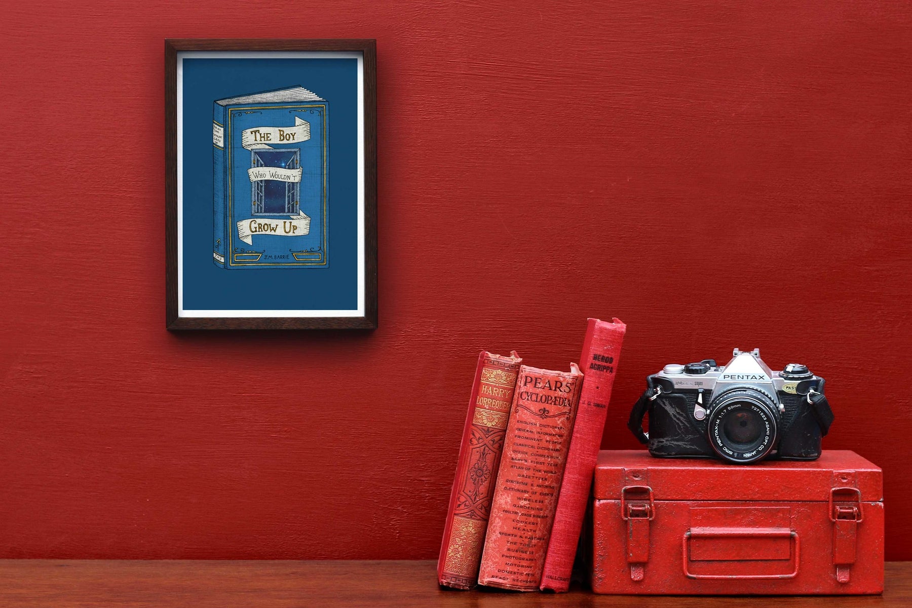 Peter Pan art print framed on a red wall