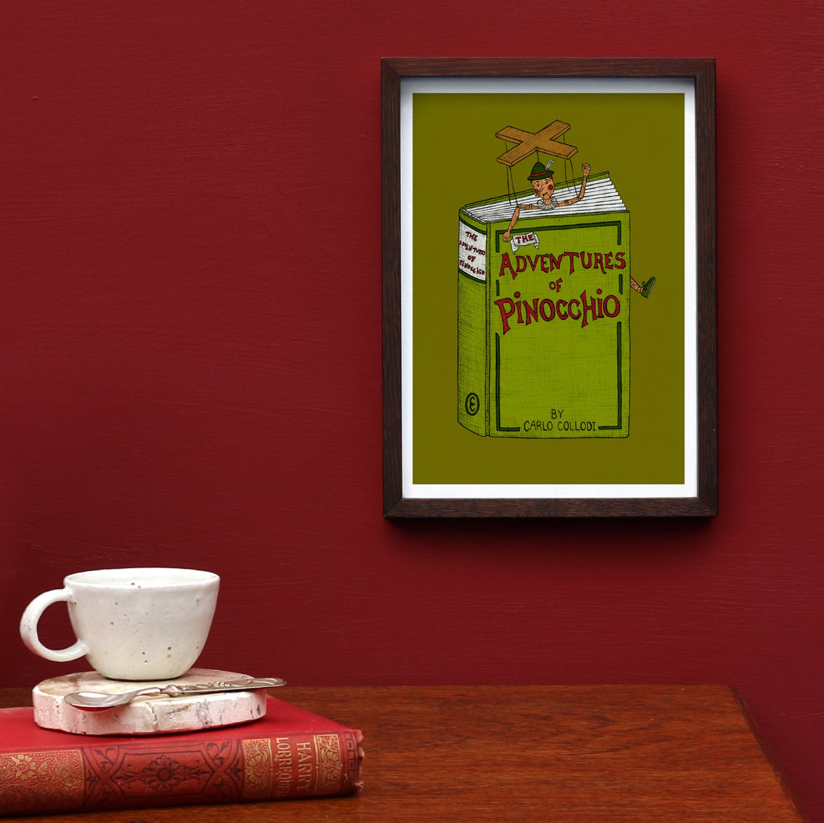 Pinocchio art print framed on a red wall