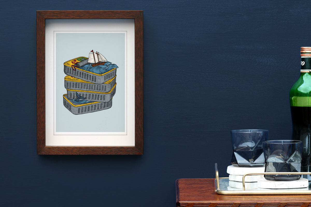 Sardine tin art print framed on a blue wall