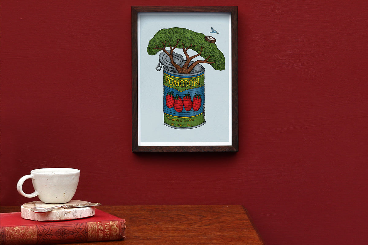 Tin of Tomatoes art print framed on a red wall