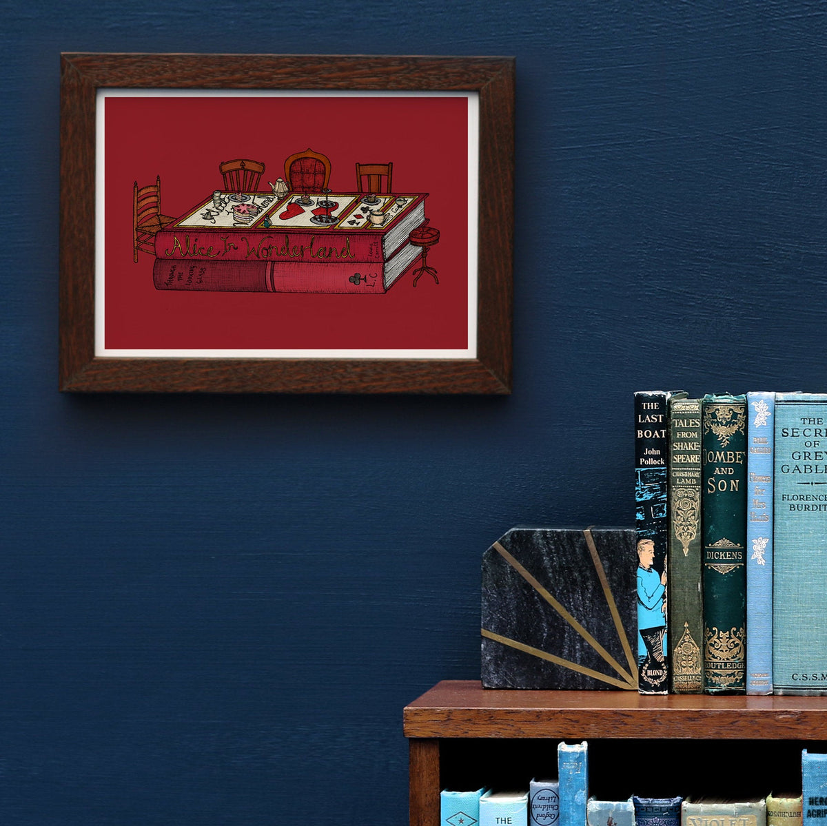 Alice in Wonderland artwork framed on a blue wall