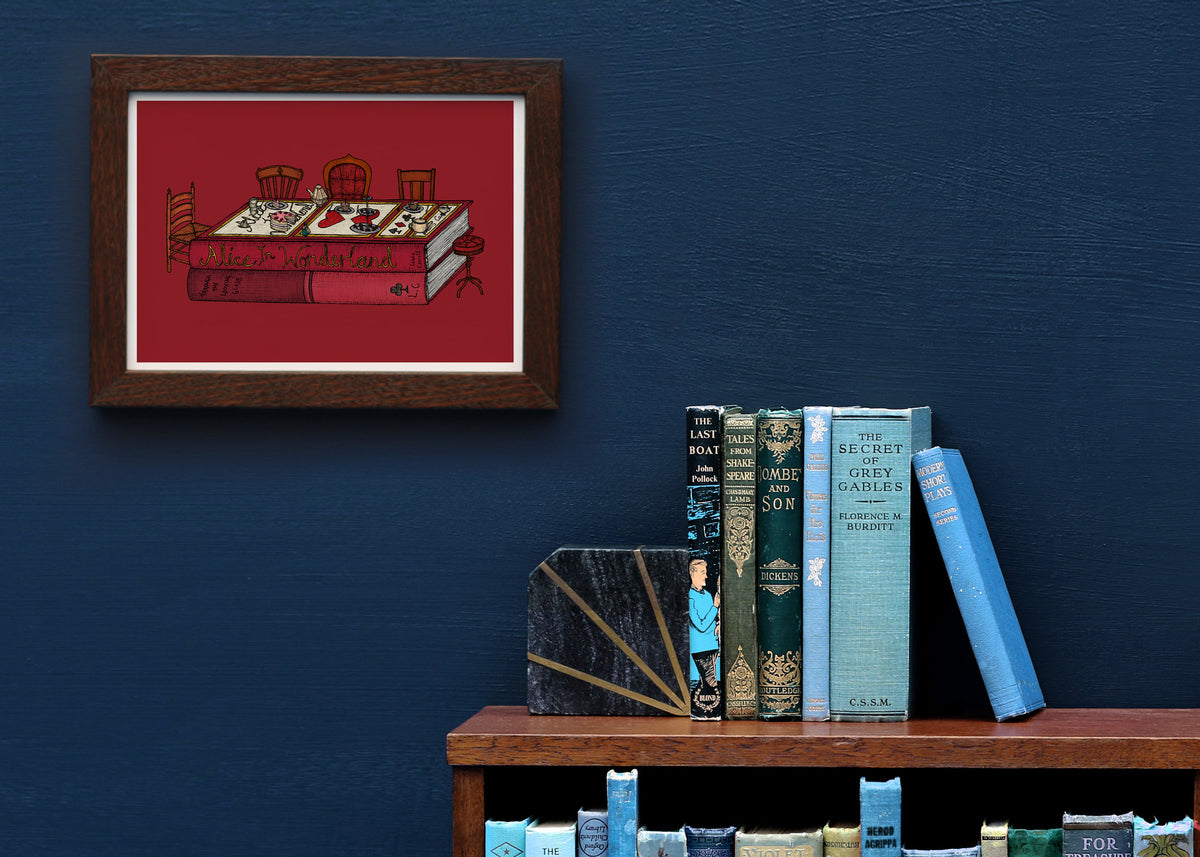 Alice in Wonderland artwork framed on a blue wall