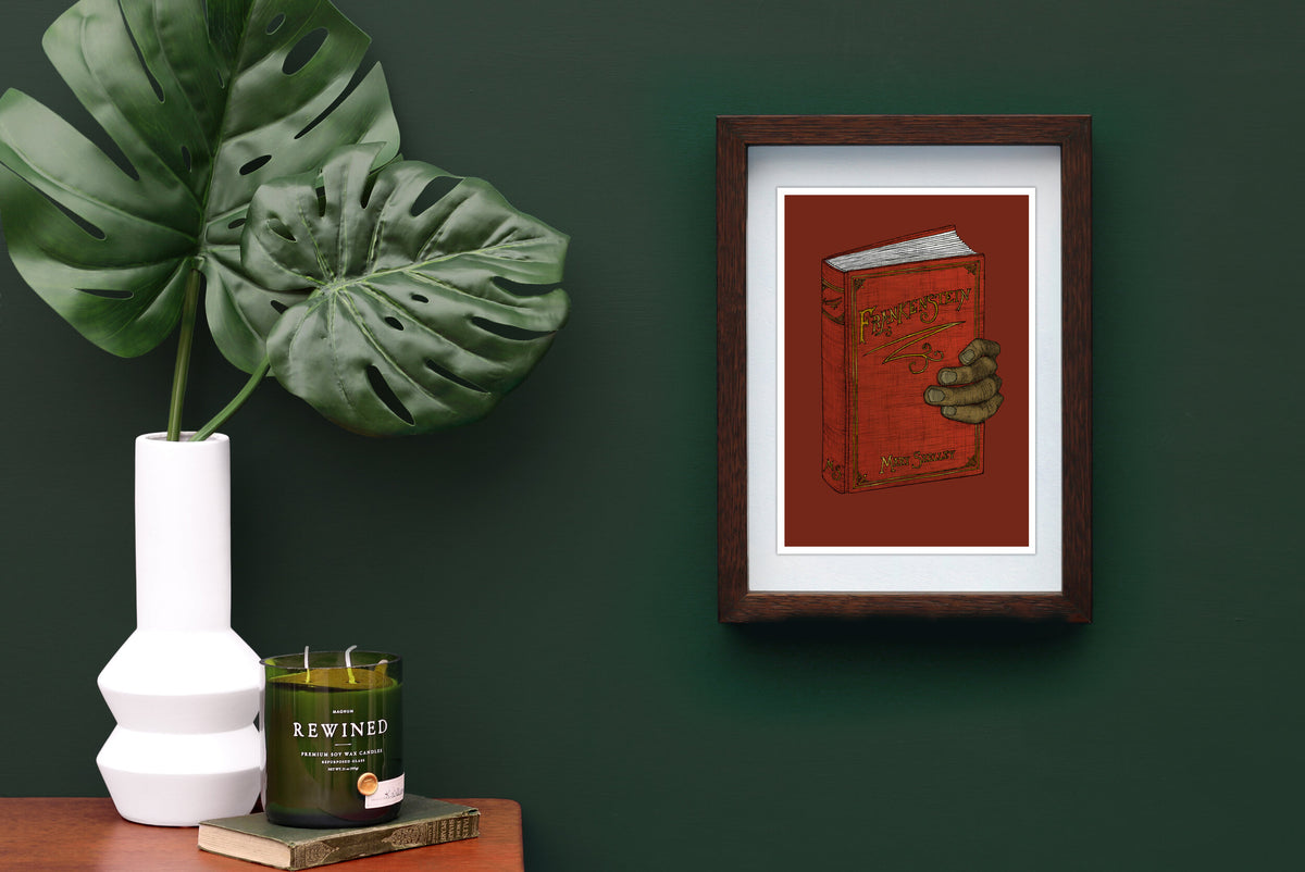 Frankenstein artwork framed on a green wall.