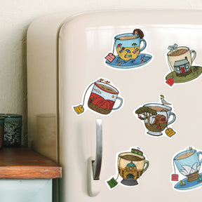 Fridge with decorative tea-themed magnets on a white wall.