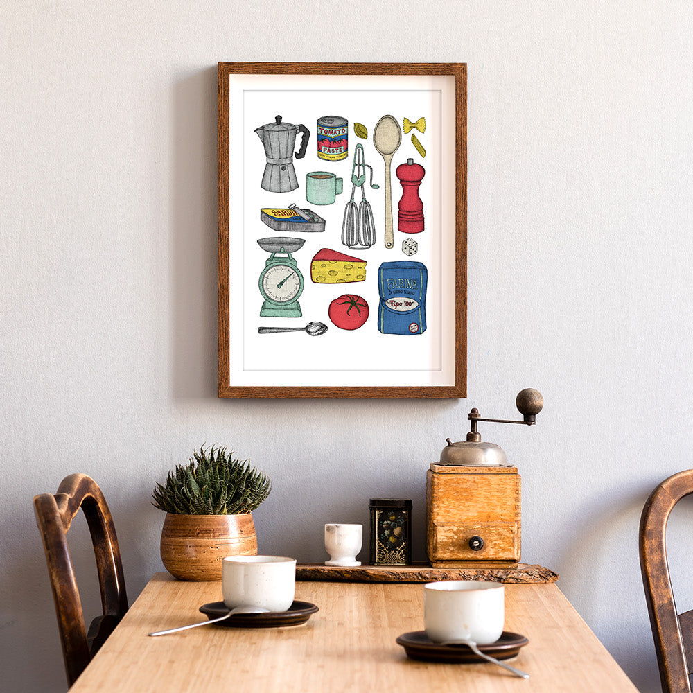 A framed art print featuring various kitchen utensils and ingredients, displayed on a wall above a dining table set with cups and a pot.