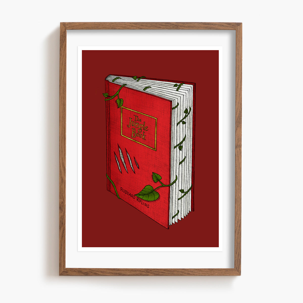 Framed artwork of a red The Jungle Book with green leaves on a white background.
