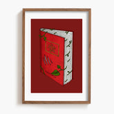 Framed artwork of a red The Jungle Book with green leaves on a white background.