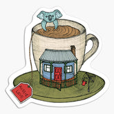 Magnet with an illustration of a cup of tea with a house and koala on a white background