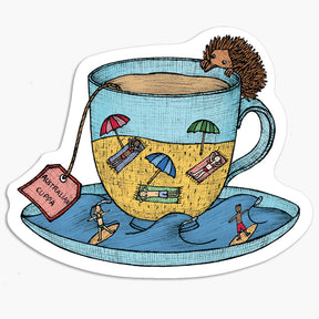 Magnet with a tea cup with an echidna, tea bag, and beach scene illustration on a white background