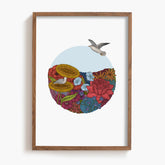 Framed artwork with a seagull flying over an ocean of flowers