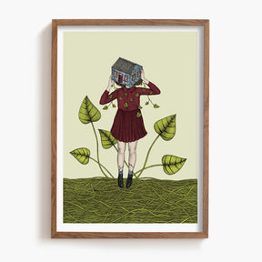 Framed artwork of a person holding a house over their face, standing on vines with leaves.