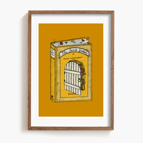 Framed artwork of a Secret Garden book with a door illustration on a yellow background