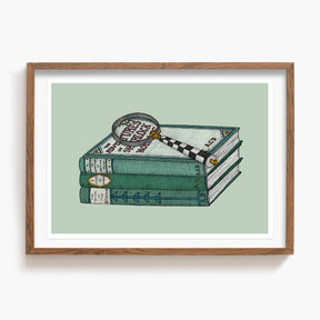 Framed artwork of a stack of a Sherlock Holmes books with a magnifying glass on a light green background