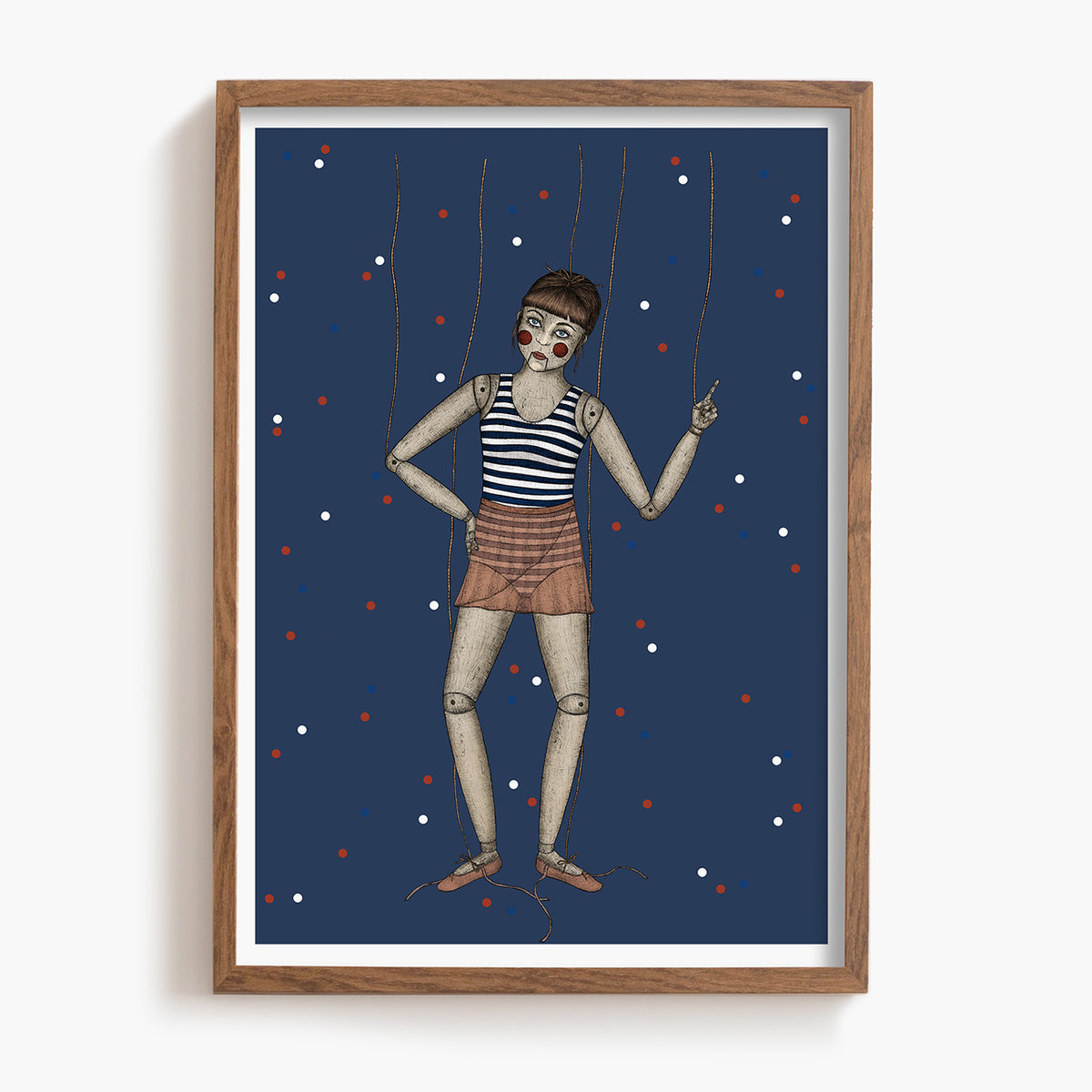 Framed artwork of a marionette against a blue background with red and white dots.