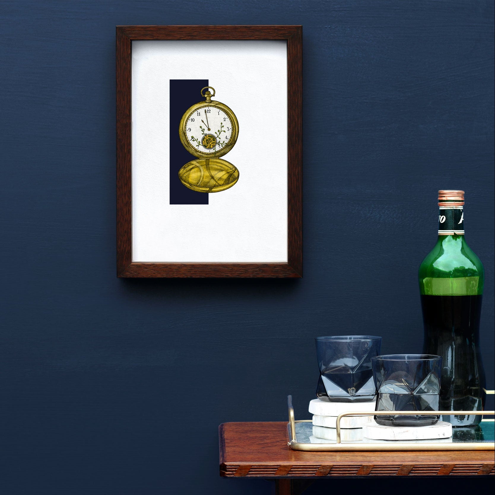 Art print featuring a whimsical illustration of a pocket watch surrounded by climbing plants, displayed on a wall above a small table with glasses and a bottle.